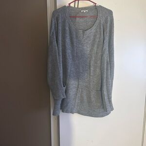 Gray sweater with pockets in the front.